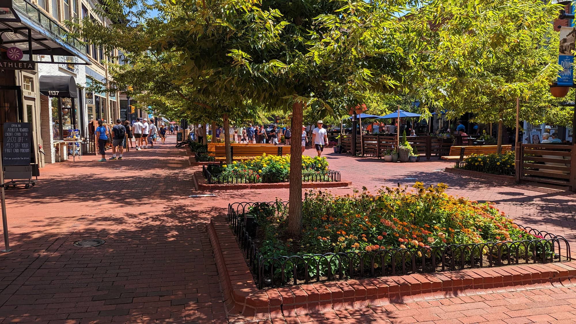 A commercial property promenade in daylight, tenants and shoppers walking